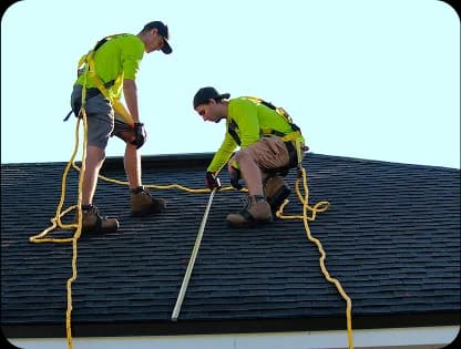 Sundance crew installing asphalt shingles on a steep roof